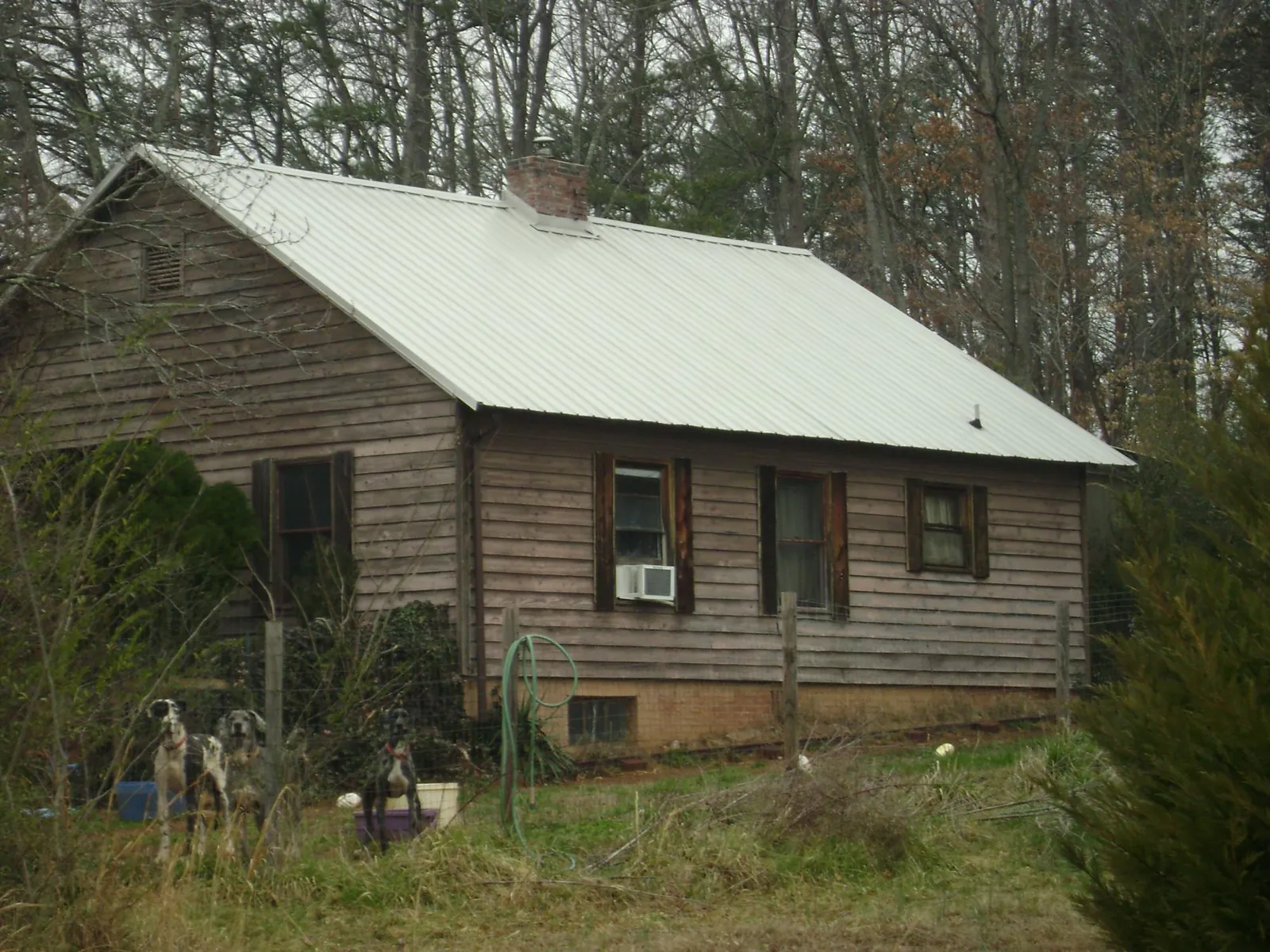 White metal roof on an old wood sided farmhouse, from a Metal Roof Installation job in Belfast